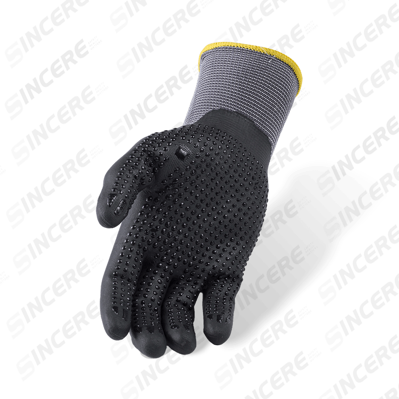 Gants en nylon élasthanne calibre 15 avec paume en micro-mousse en nitrile noir et poignée antidérapante à pois en nitrile